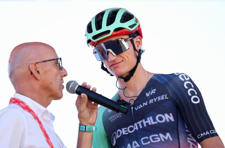 Cyclist Felix Gall riding his bike during La Vuelta. He looks focused on the road ahead.