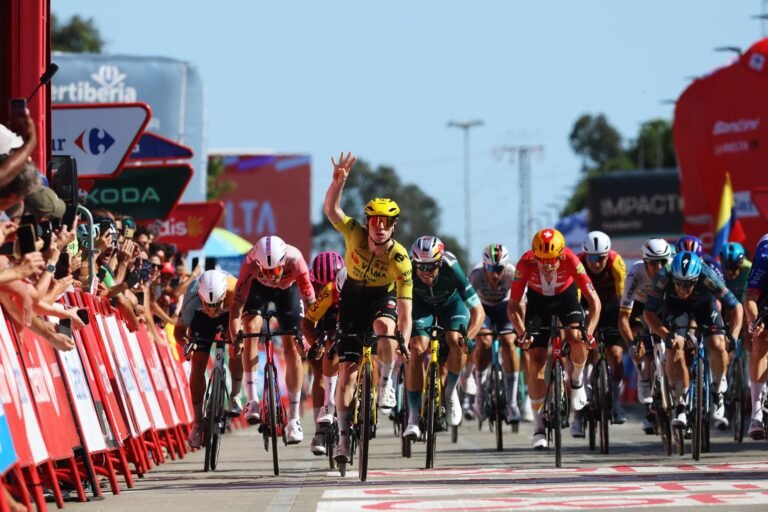Alt Text: Visma Lease a Bike leadout train guiding Matthew Brennan in a Grand Tour sprint.