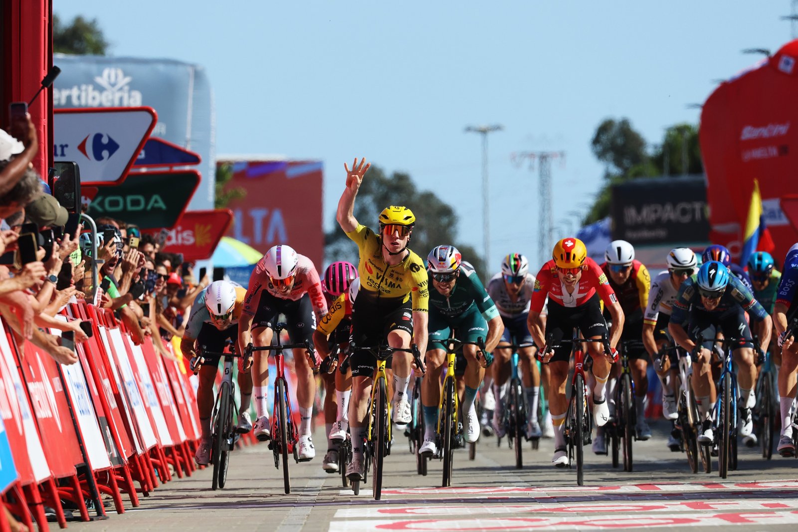Alt Text: Visma Lease a Bike leadout train guiding Matthew Brennan in a Grand Tour sprint.