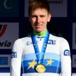 Tadej Pogačar wearing the world champion rainbow jersey during a 2026 road race