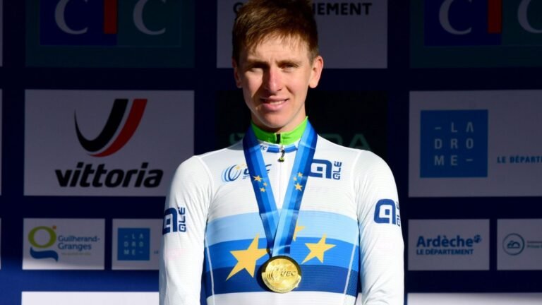 Tadej Pogačar wearing the world champion rainbow jersey during a 2026 road race