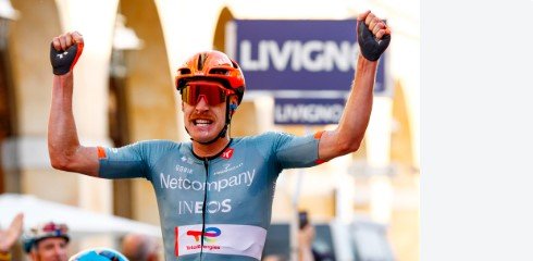 Dorian Godon crossing the finish line with arms raised in victory at Gran Piemonte 2026 in Bra