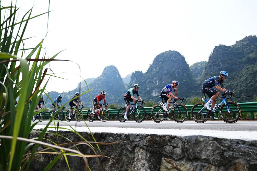Cyclists approaching the finish line banner in the modern city of Nanning.