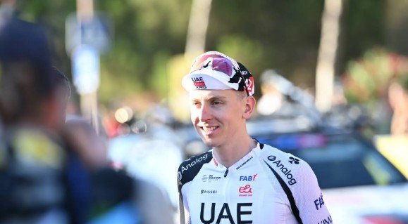 Tadej Pogačar in UAE Team Emirates jersey looking thoughtful during a post-stage interview.