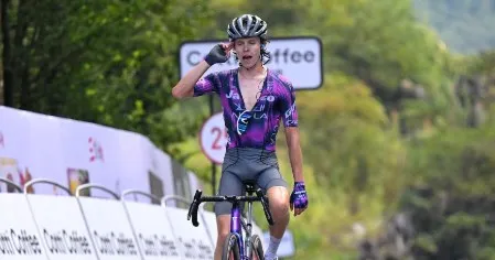 Peloton riding along scenic river landscapes and rolling hills on Stage 5 of Tour of Guangxi.