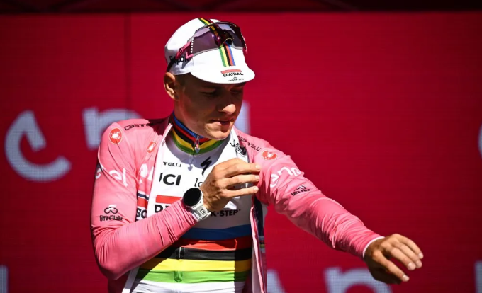 Remco Evenepoel riding in time trial position during a Grand Tour stage.