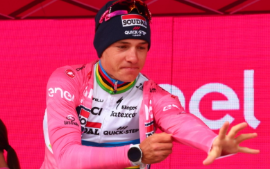 Remco Evenepoel riding in time trial position during a Grand Tour stage.